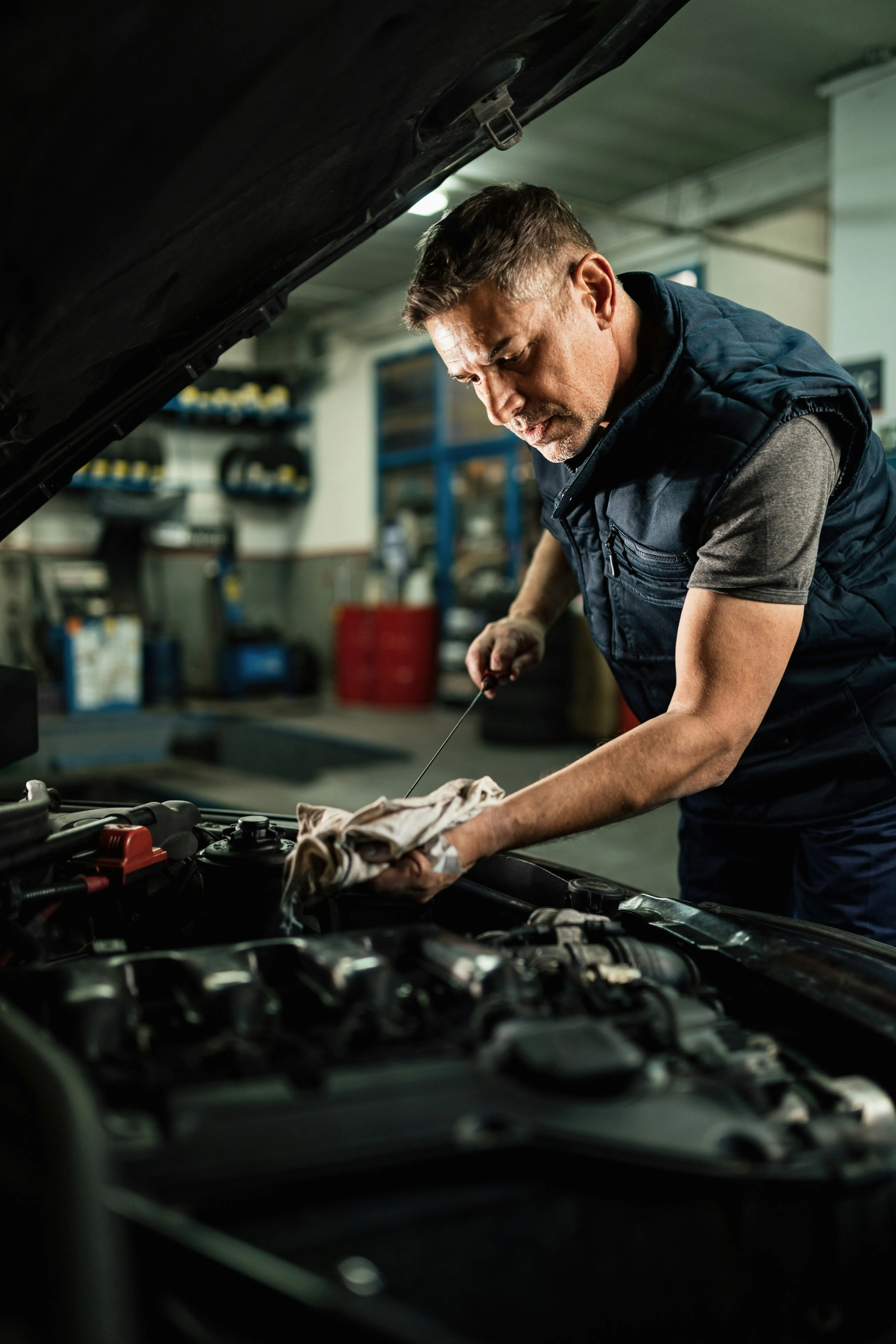 Professional mechanic performing diagnostic assessment